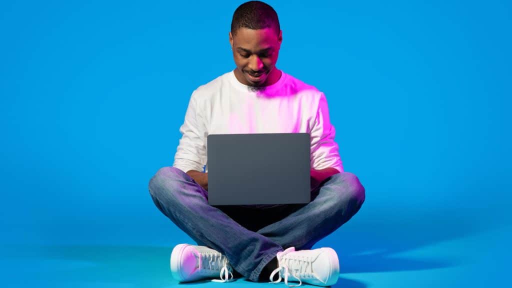A young man engages with his laptop, a visual metaphor for getting started with big data in today's digital world.